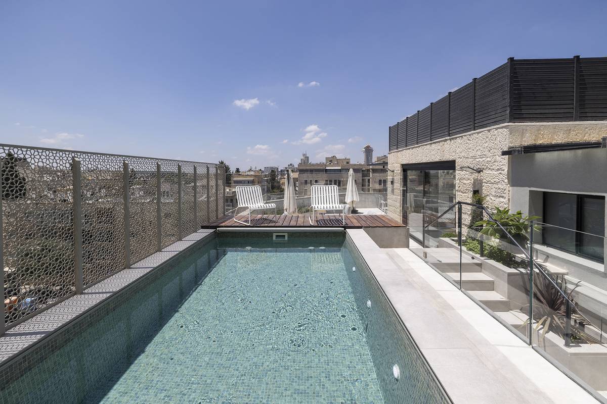 Heated rooftop pool and outdoor dining terrace at Aura Penthouse Jerusalem – photo 11